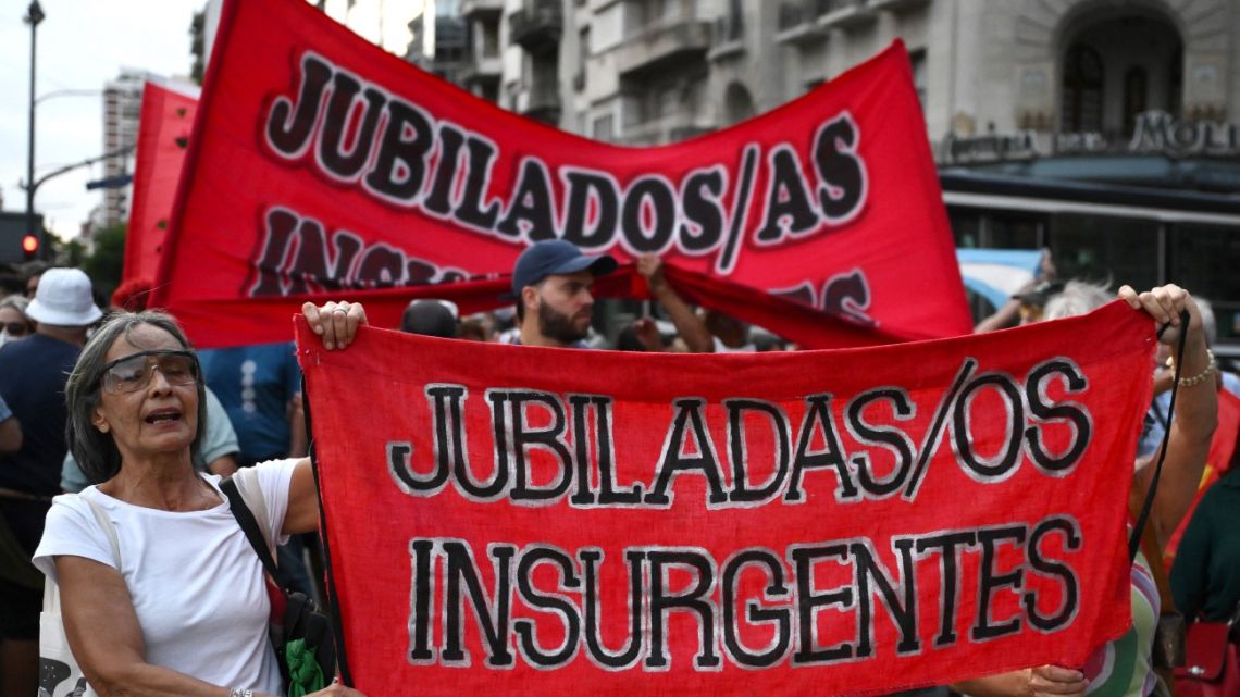 Pensioners display a banner during a protest called by pensioners asking for an increase in pensions outside the National Congress in Buenos Aires on February 26, 2025. 