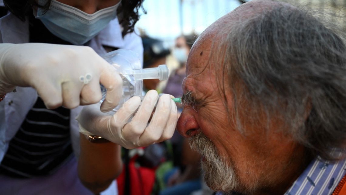 A man affected by teargas reacts as he is treated during a protest called by pensioners asking for an increase in pensions outside the National Congress in Buenos Aires on February 26, 2025. 