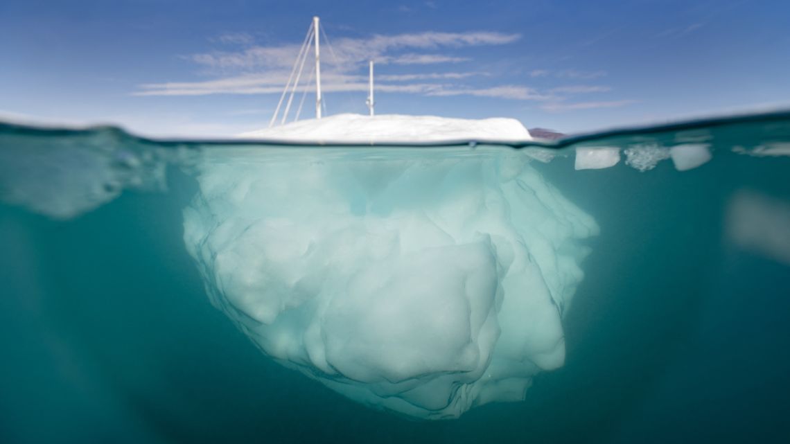 The Greenlandia expedition's sailing boat 'Kamak' sails between icebergs released by glaciers around Milne Land in the Scoresby Sound Fjord, Eastern Greenland on August 15, 2023.