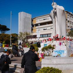  La gente reza ante la estatua de Juan Pablo II en el exterior del Hospital Universitario Gemelli, donde el Papa Francisco está hospitalizado. Foto de Dimitar DILKOFF / AFP | Foto:AFP