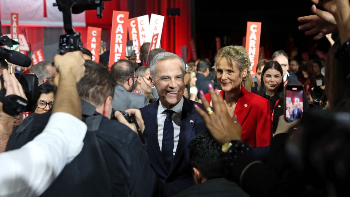 Canada's Liberal Leader and Prime Minister-elect Mark Carney (C) greets supporters after being elected as the new Liberal Party leader, in Ottawa on March 9, 2025.