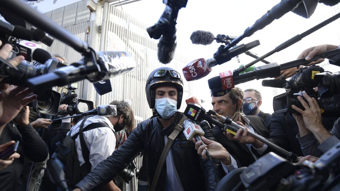 The personal physician of Argentine former football star and coach Diego Maradona, Leopoldo Luque, speaks to members of the media as he leaves the clinic where Maradona underwent brain surgery for a blood clot, in Olivos, Buenos Aires province, on November 11, 2020.