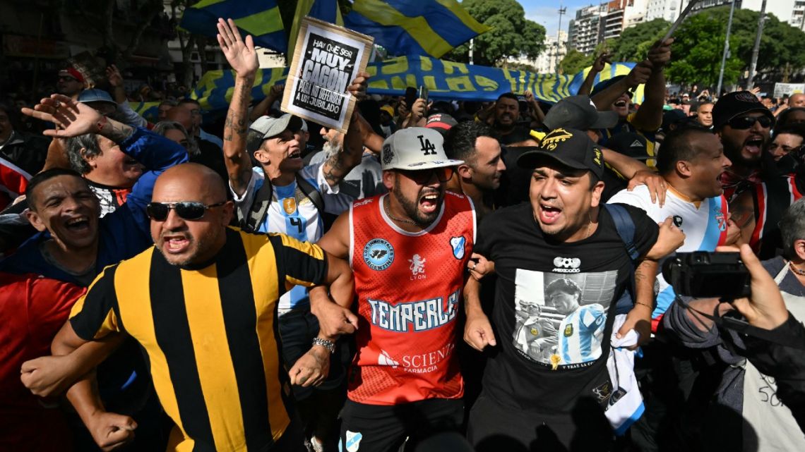 Football fans take part in a protest of pensioners against the government of President Javier Milei in Buenos Aires on March 12, 2025. 