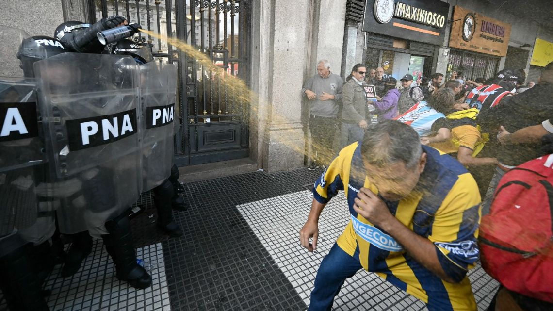 A police officer uses pepper spray during a protest of pensioners supported by football fans against the government of President Javier Milei in Buenos Aires on March 12.