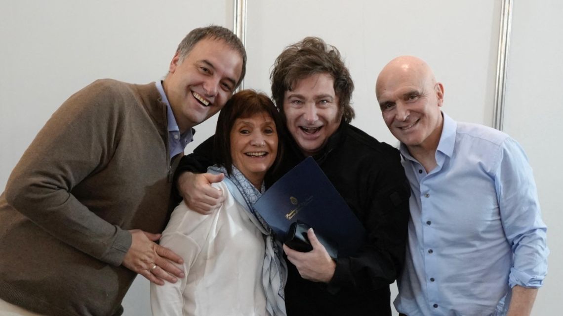 Handout photo released by Argentina's Presidency press office showing Argentine President Javier Milei (2-R) posing with Security Minister Patricia Bullrich (2-L) the President spokesman Manuel Adorni (L) and ruling party legislator Jose Luis Espert at the "Expoagro" agricultural exhibition in San Nicolas de los Arroyos, Buenos Aires Province, Argentina, on March 14, 2025. 