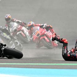 El piloto italiano de Aprilia Racing, Marco Bezzecchi, se cae de su moto al inicio de la carrera del Gran Premio de Argentina de MotoGP en el circuito de Termas de Río Hondo en Santiago del Estero, Argentina. | Foto:LUIS ROBAYO / AFP
