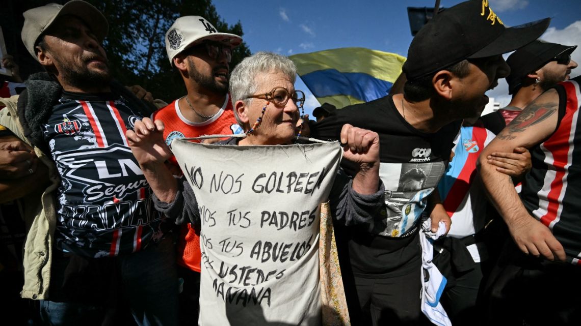 Football fans take part in a protest of pensioners against the government of President Javier Milei in Buenos Aires on March 12, 2025.