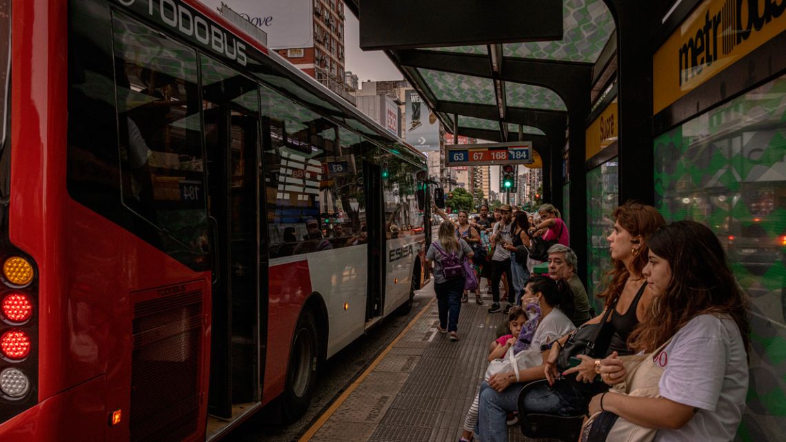 Passengers wait at a bus stop in Buenos Aires.