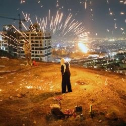 Los iraníes encienden fuegos artificiales durante la Fiesta del Fuego que se celebra anualmente en Teherán. | Foto:ATTA KENARE / AFP