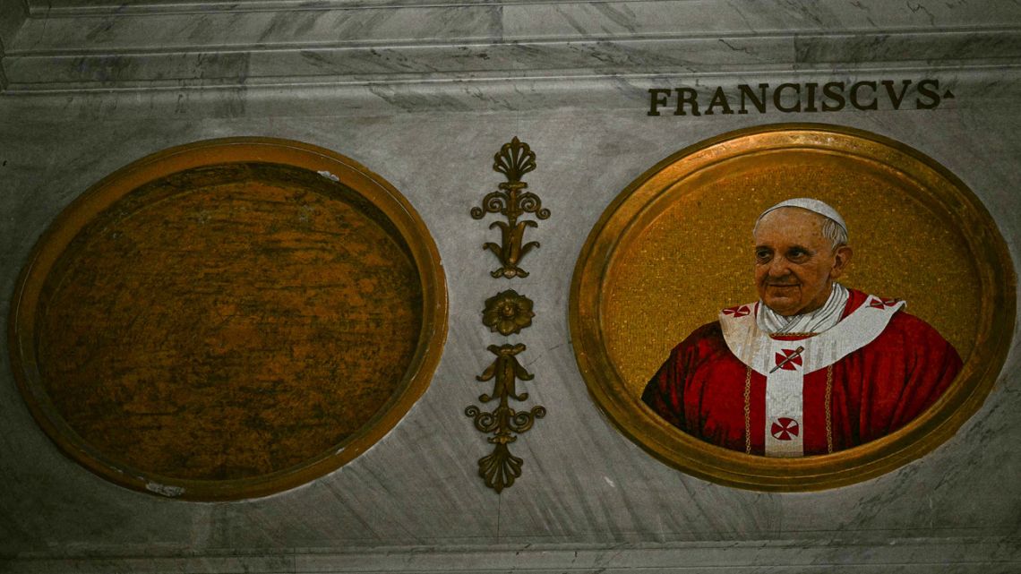 This photograph a shows a view of a mozaic portrait of late Pope Francis (R) and an empty space for the next pope to be elected in an upcoming conclave, inside of the Basilica of Saint Paul Outside the Walls in Rome on April 30, 2025. 