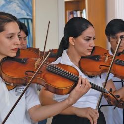 Members of the Orquesta de los Barrios youth orchesta: Micaela Sandoval, Ruth Geréz, Lucas Flores.