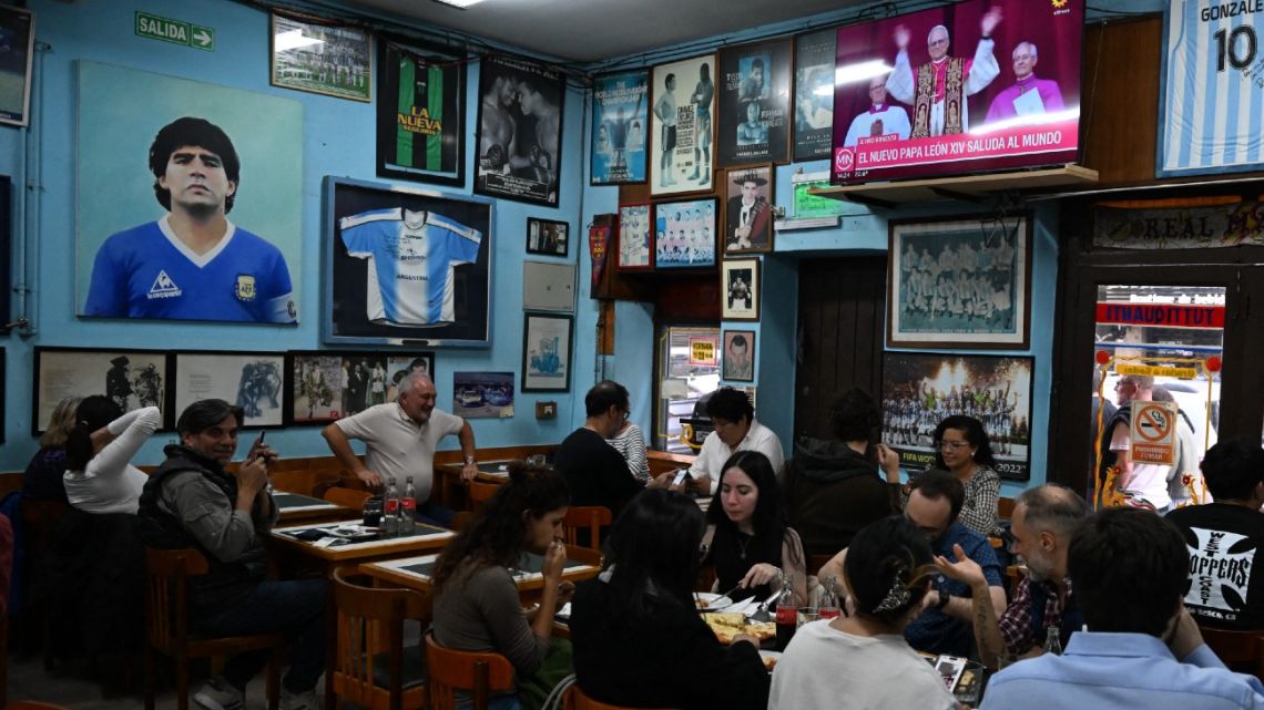 People sit in a restaurant in Buenos Aires on May 8, 2025. 