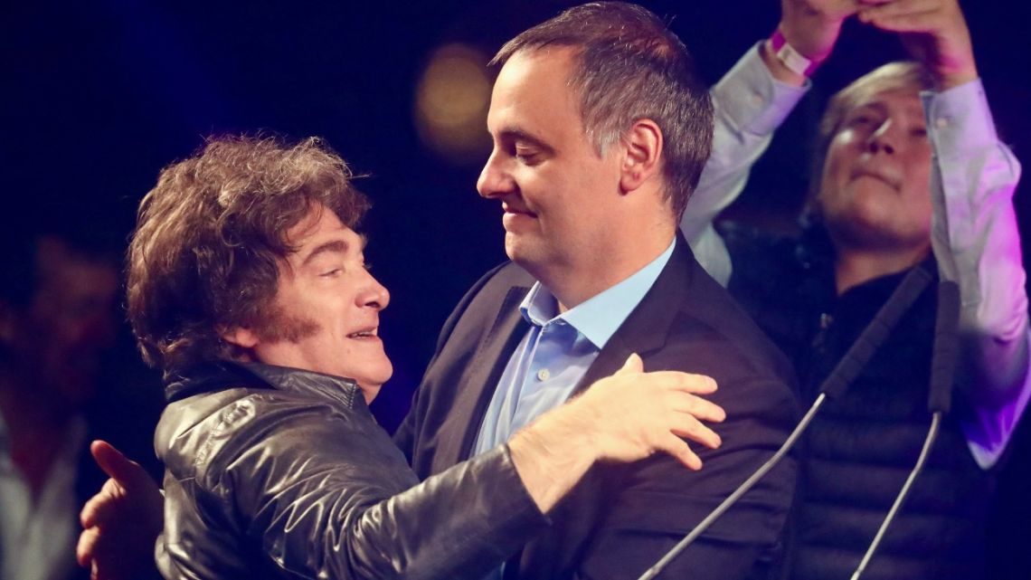 Argentina's President Javier Milei embraces Presidential Spokesperson and legislative candidate Manuel Adorni during his closing campaign rally in Buenos Aires on May 14, 2025. Buenos Aires City will hold legislative elections on May 18. 