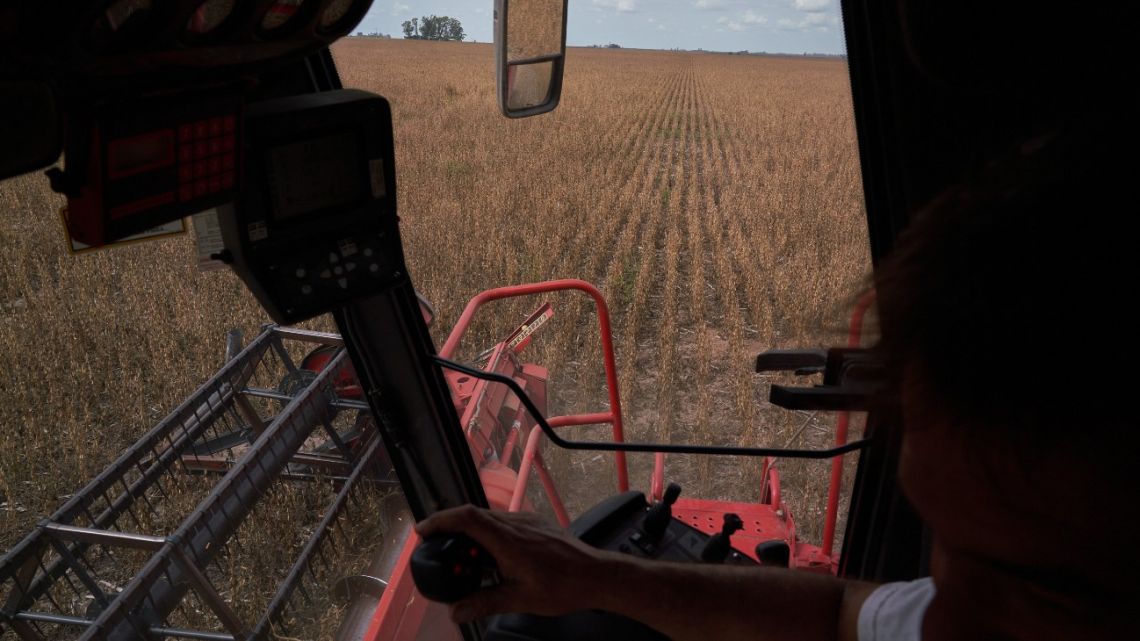 A combine harvester cuts through a field of soybean plants San José de la Esquina, Argentina. 