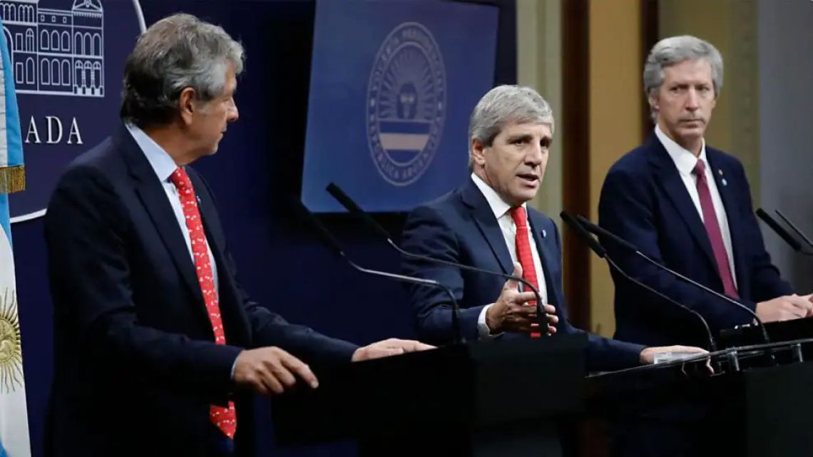 ARCA tax bureau chief Juan Pazo; Economy Minister Luis Caputo, Central Bank Governor Santiago Bausili.