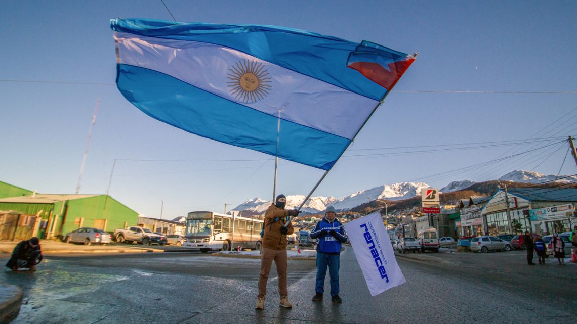 A man waves an Argentine flag also carrying the flag of Tierra del Fuego Province in one of its corners during a protest against President Javier Milei's tariff policy in Ushuaia, Argentina, on May 21, 2025. 