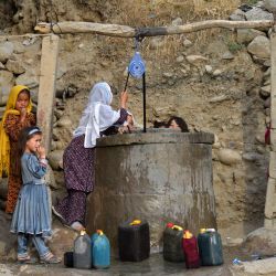 Niñas afganas recogen agua de un pozo en el distrito de Fayzabad, provincia de Badakhshan. | Foto:OMER ABRAR / AFP