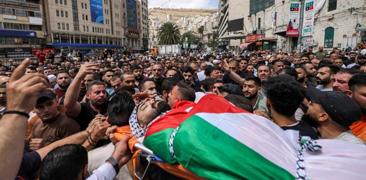 Los dolientes cargan el cuerpo del palestino Mahmoud al-Kharraz, de 32 años, asesinado previamente en una redada del ejército israelí, durante su funeral en Nablus, Cisjordania ocupada.