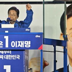 Jae-myung, candidato presidencial del Partido Democrático de Corea del Sur, gesticula tras un cristal antibalas. Foto: ANTHONY WALLACE / AFP | Foto:AFP
