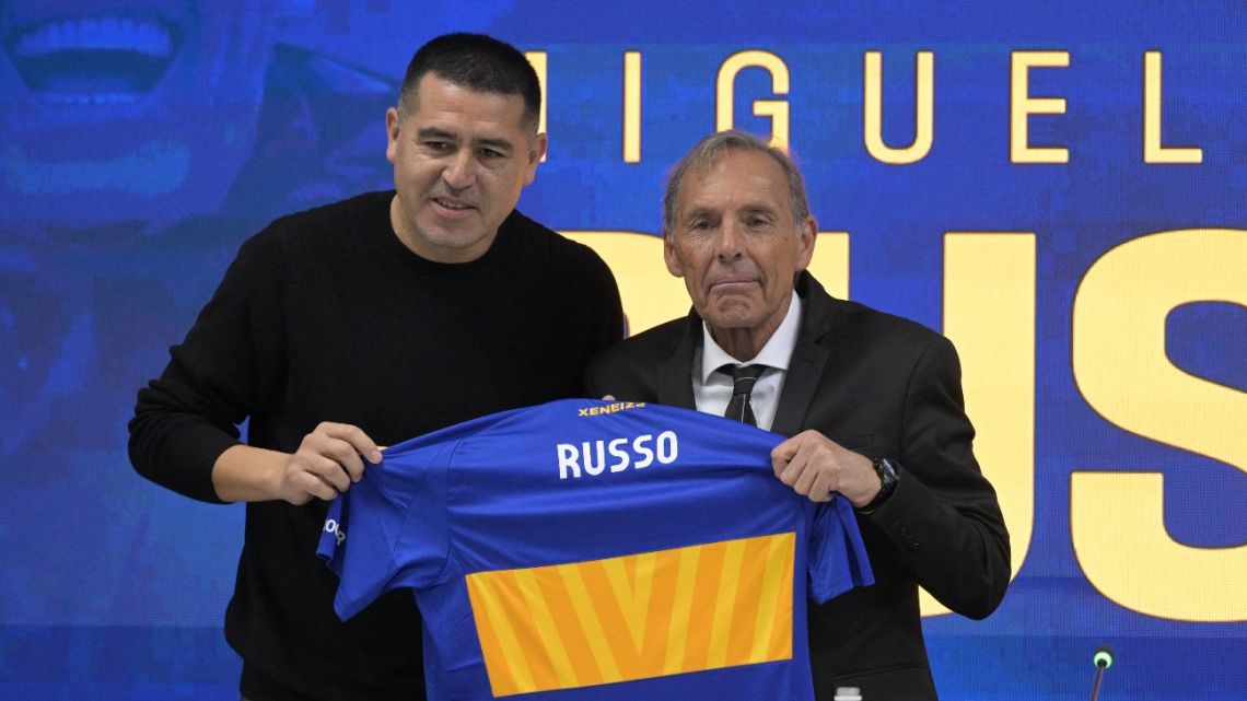 Boca Juniors Club President Juan Román Riquelme and new coach Miguel Ángel Russo hold up a shirt during the latter's presentation as new Xeneize coach, in Ezeiza, Buenos Aires Province, on June 2, 2025. 