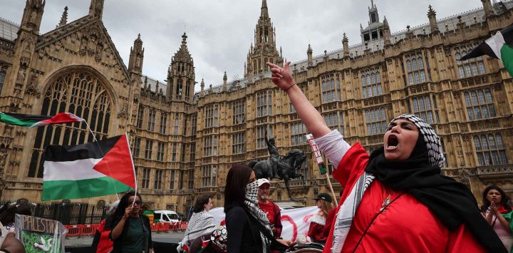 Manifestantes ondean banderas palestinas y corean consignas frente al Palacio de Westminster. Foto de Adrian Dennis / AFP 