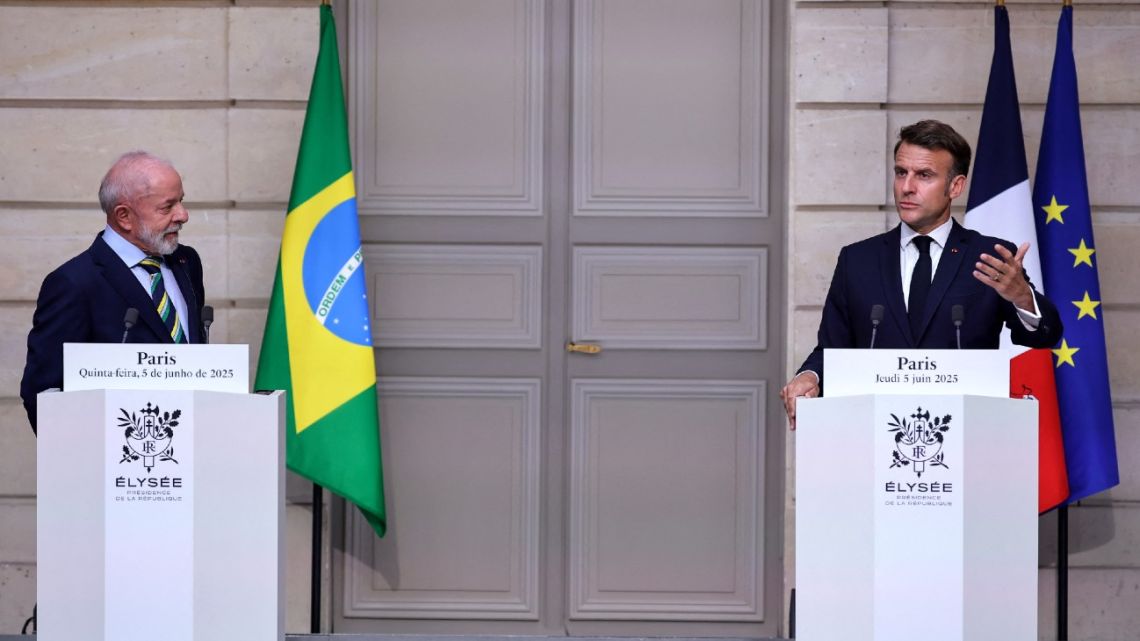 Brazil's President Luiz Inácio Lula da Silva listens to France's President Emmanuel Macron as they address a joint press conference following a meeting at the Élysée Presidential Palace in Paris on June 5, 2025.