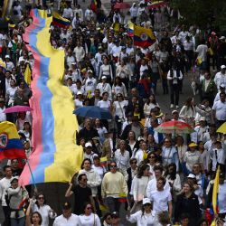 Personas participan en una marcha por la paz en Bogotá, un día después del atentado contra el candidato presidencial Miguel Uribe. Un destacado candidato presidencial colombiano de derecha, que recibió un disparo durante un acto de campaña en Bogotá, fue sometido con éxito a una primera cirugía, según informó el alcalde de la ciudad. | Foto:RAUL ARBOLEDA / AFP
