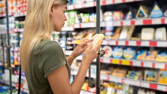 A shopper checks the price of cheese at a supermarket in Buenos Aires City. 