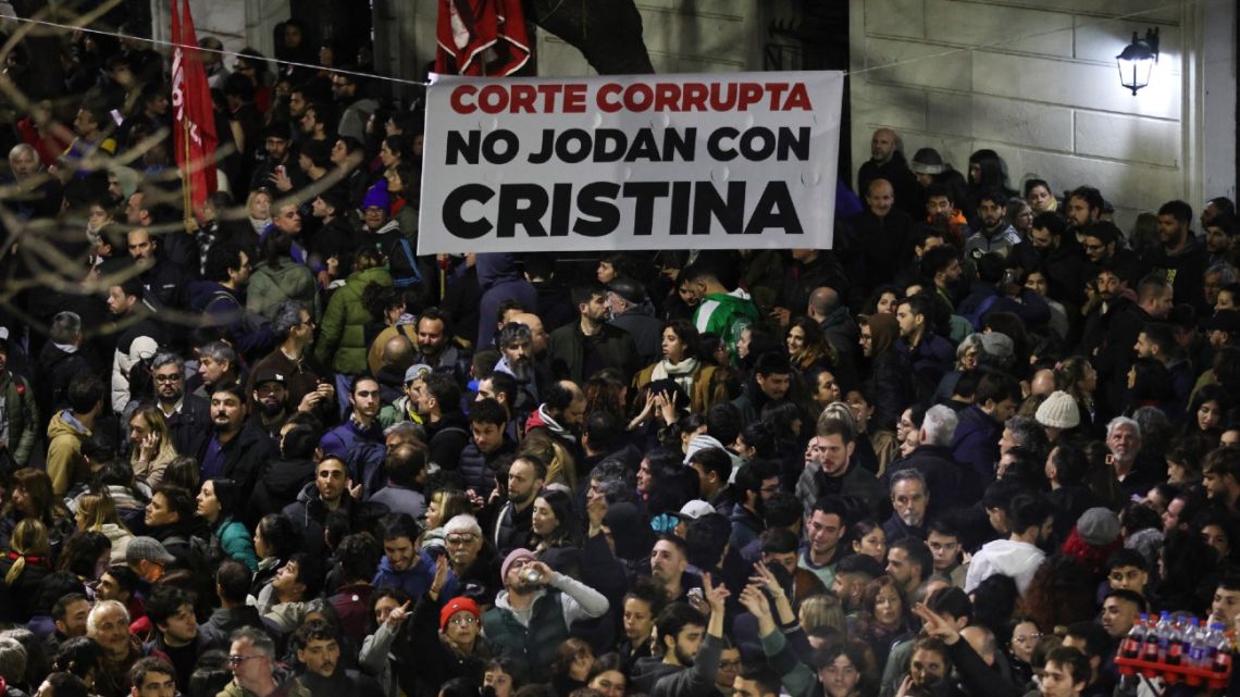 A banner that reads in Spanish, 'Corrupt court, don't mess with Cristina,' is seen while supporters of former president Cristina Fernandez de Kirchner gather outside her home in Buenos Aires on June 10, 2025. 
