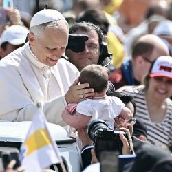 El Papa León XIV bendice a un niño a su llegada para la audiencia general semanal en la Plaza de San Pedro del Vaticano. | Foto:Filippo Monteforte / AFP