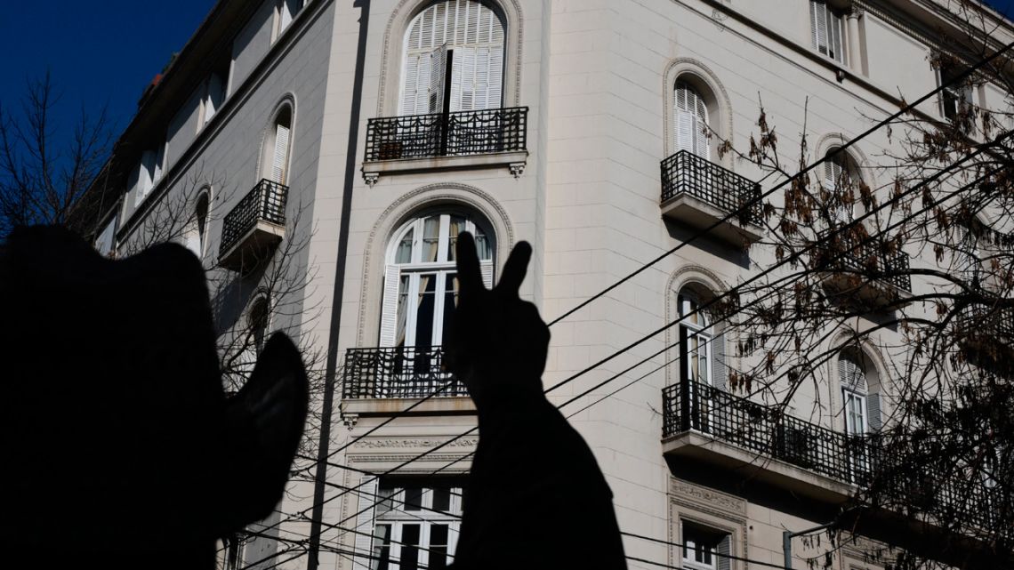 A supporter of Cristina Fernández de Kirchner flashes the V sign outside her residence in Buenos Aires on June 11, 2025. 