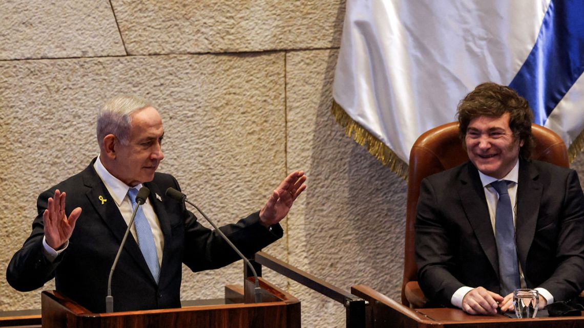 Argentina's President Javier Milei looks on as Israel's Prime Minister Benjamin Netanyahu addresses the Israeli parliament (Knesset) at its headquarters in Jerusalem on June 11, 2025.