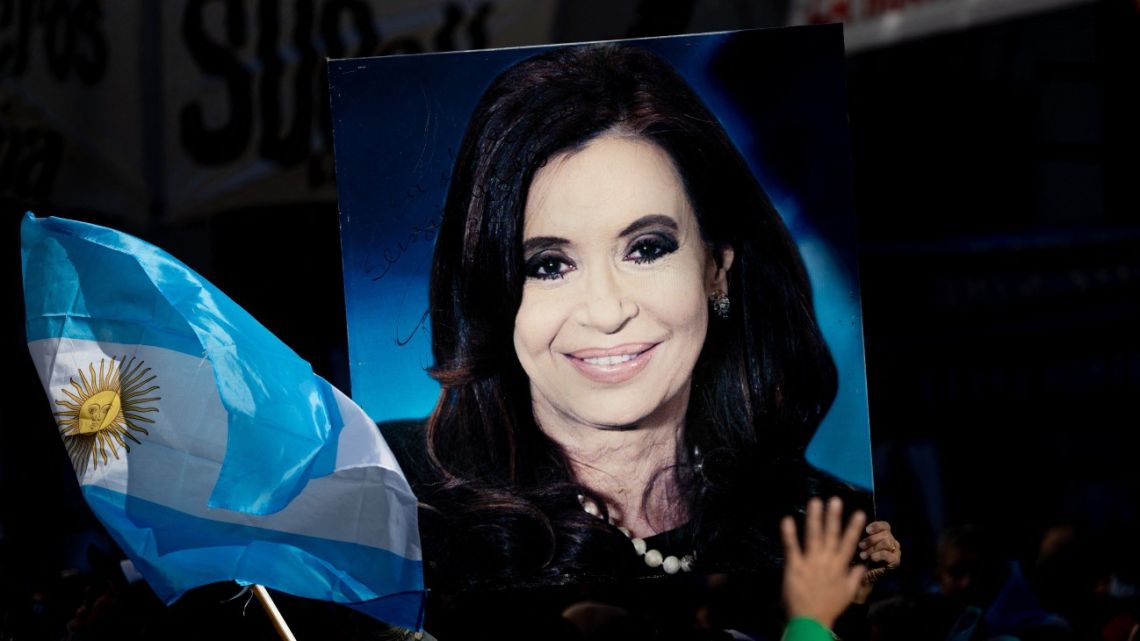 A supporter holds a portrait of former president Cristina Fernández de Kirchner outside her residence in Buenos Aires on June 18, 2025. 