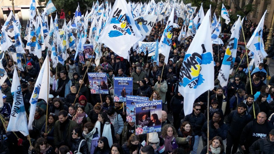 Supporters of Argentina's former president Cristina Fernández de Kirchner take part in a protest march against her conviction and house arrest in Buenos Aires on June 18, 2025. 