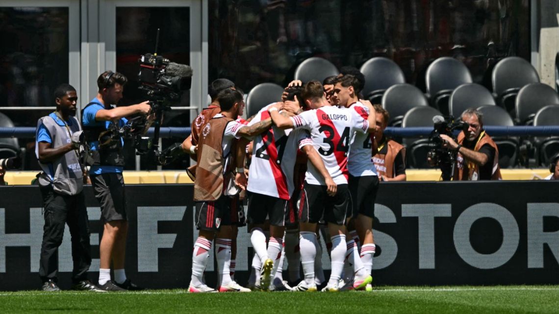 River Plate's midfielder Maximiliano Meza (hidden) is congratulated by teammates after scoring a goal during the FIFA Club World Cup 2025 Group E football match between Argentina's River Plate and Japan's Urawa Red Diamonds at the Lumen Field stadium in Seattle on June 17, 2025. 
