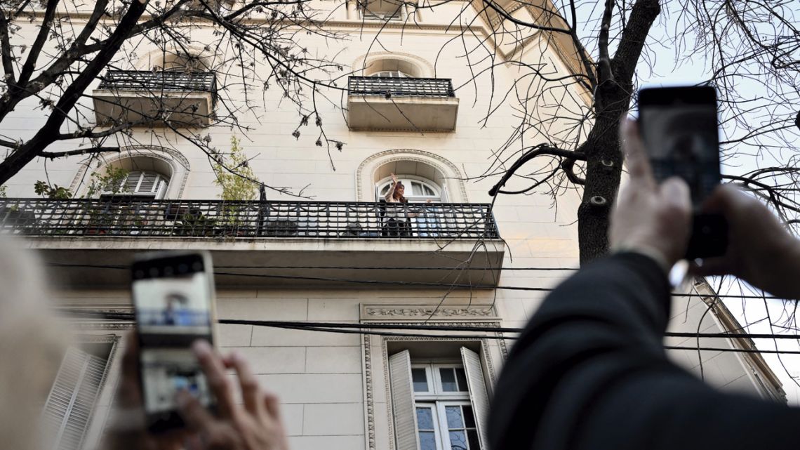 Cristina Fernández de Kirchner waves to supporters from the balcony of her residence in Buenos Aires.