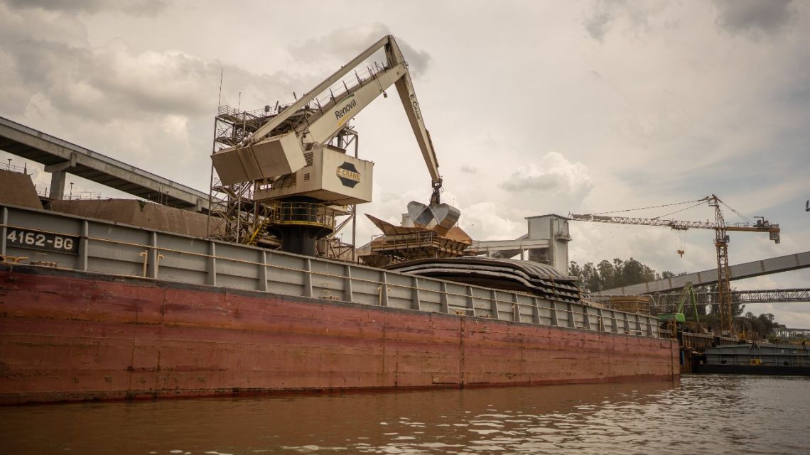 Crops are loaded onto a ship along the Paraná River waterway in Rosario, Argentina.