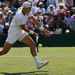 El danés Holger Rune devuelve un golpe de derecha al chileno Nicolás Jarry durante el Campeonato de Wimbledon 2025. Foto de Glyn KIRK / AFP | Foto:AFP