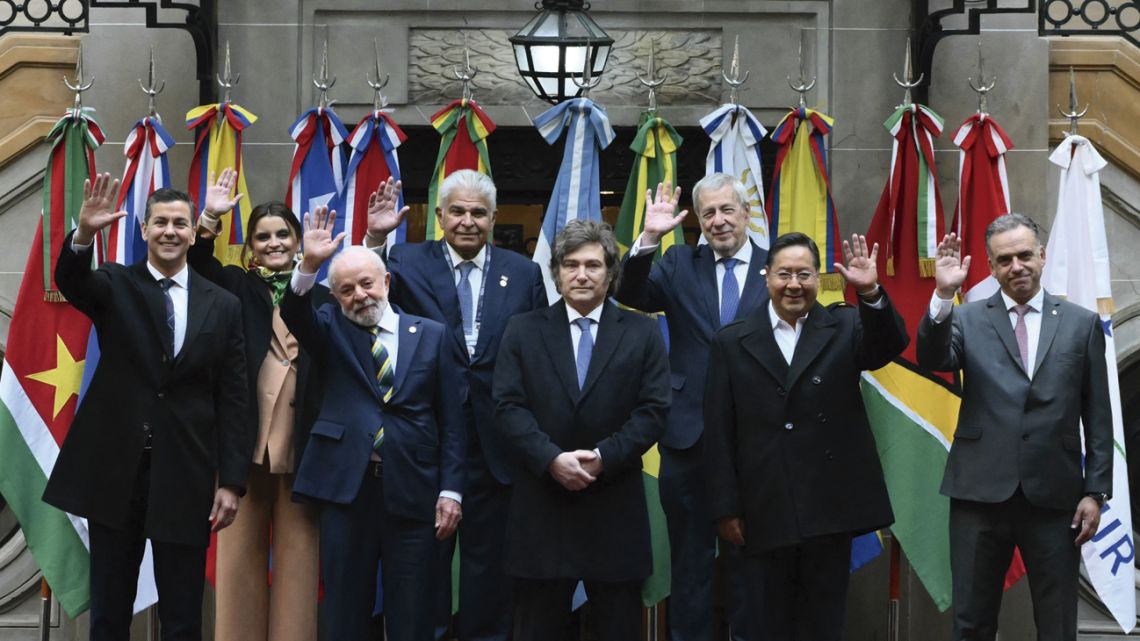 Mercosur leaders and invited guests: (Left to right, back row) Ecuador's Vice-President María José Pinto, Panama's President José Raúl Mulino, and Chile's Foreign Minister Alberto van Klaveren; (Left to right, front row) Paraguay's President Santiago Peña, Brazil's President Luiz Inácio Lula da Silva, Argentina's President Javier Milei, Bolivia's President Luis Arce Catacora and Uruguay's President Yamandú Orsi, wave as they pose for the family photo during the 66th Summit of Leaders of Mercosur and Associated States at the Palacio San Martín in Buenos Aires.