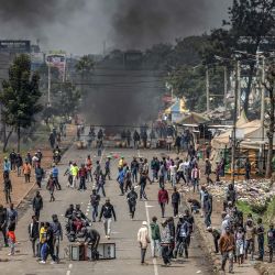 Manifestantes se congregan para bloquear una carretera principal con barricadas incendiadas y escombros urbanos durante los enfrentamientos en las manifestaciones del Día de Saba Saba en Nairobi, Kenia. | Foto:LUIS TATO / AFP
