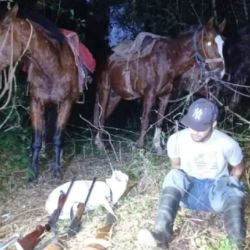El cazador furtivo detenido, junto a las armas incautadas.