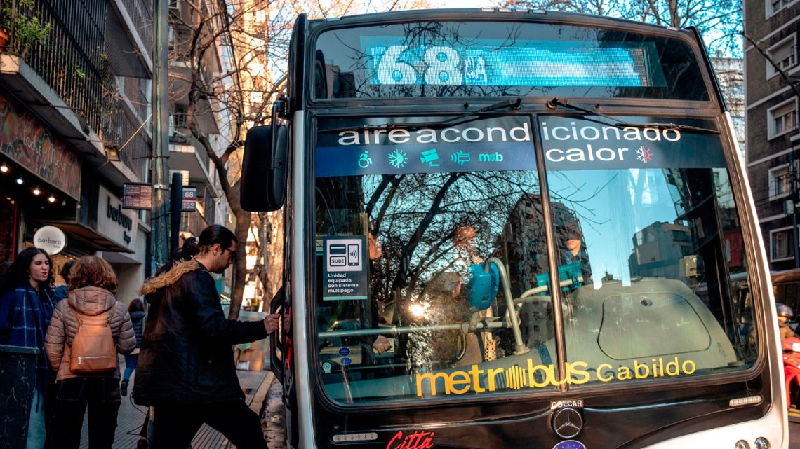 Commuters board a public transit bus in Buenos Aires, Argentina, on Saturday, July 12, 2025. 