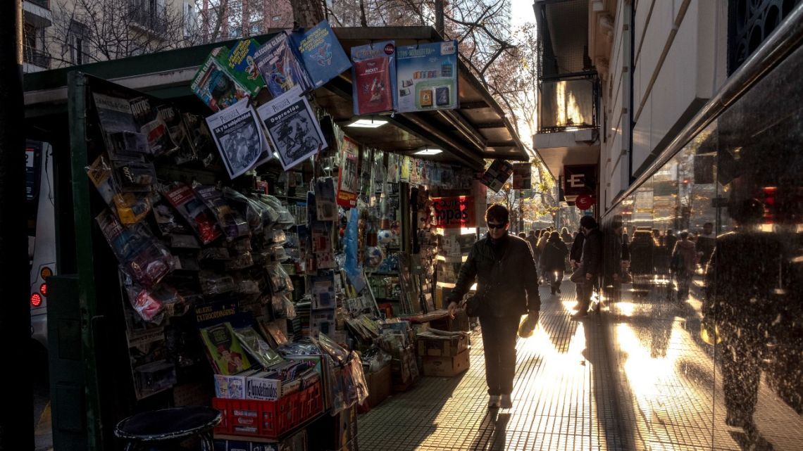 Pedestrians walk past a newsstand in Buenos Aires, Argentina, on July 12, 2025.
