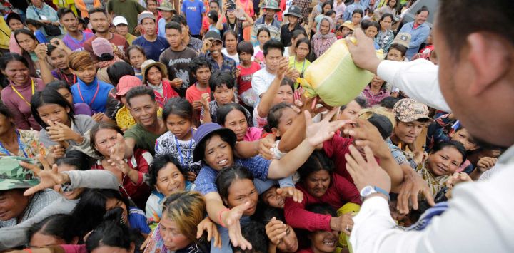 Personas que huyeron de sus hogares cerca de la frontera entre Camboya y Tailandia se reúnen para recibir ayuda temporal en un centro de evacuación en la provincia camboyana de Preah Vihear.