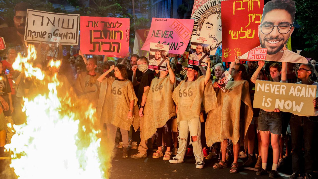Manifestantes se congregan ante una hoguera durante una protesta antigubernamental para exigir la liberación de los rehenes israelíes retenidos en la Franja de Gaza por militantes palestinos desde los atentados del 7 de octubre de 2023. | Foto:JACK GUEZ / AFP