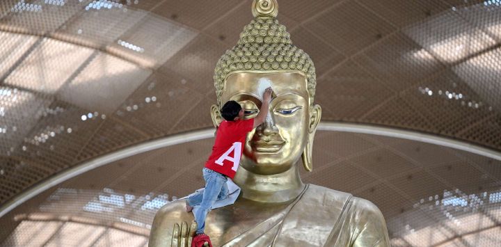 Un trabajador limpia una estatua de Buda en el recién construido Aeropuerto Internacional de Techo, en la provincia de Kandal, Camboya.