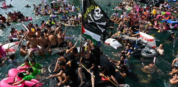 Los participantes parten del puerto en balsas improvisadas para llegar a la playa de la Bahía de La Concha durante la fiesta "Pirata Abordaia" en la ciudad vasca de San Sebastián, España.