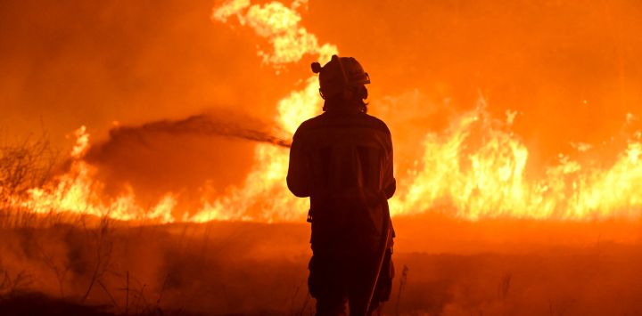 Un bombero trabaja para extinguir un incendio forestal en el pueblo de Vilaza, cerca de Verín, provincia de Ourense, noroeste de España.