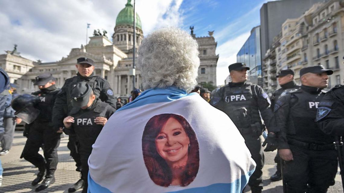 A supporter of ex-president Cristina Fernández de Kirchner demonstrates at the weekly pensioners protest outside Congress in Buenos Aires.