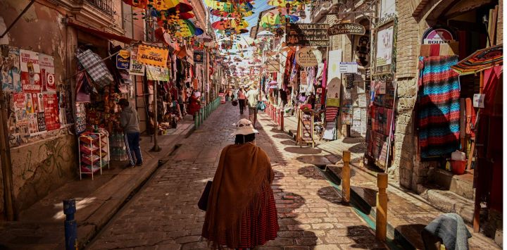 Una mujer camina por una calle frente al Mercado de las Brujas en La Paz, Bolivia.